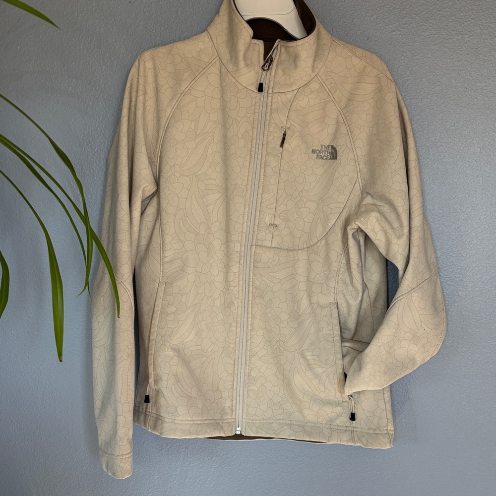 THE NORTH FACE TNFAPEX jacket. Floral design. Wind guard waist strap. Size med